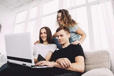 Three professionals are watching videos from social media