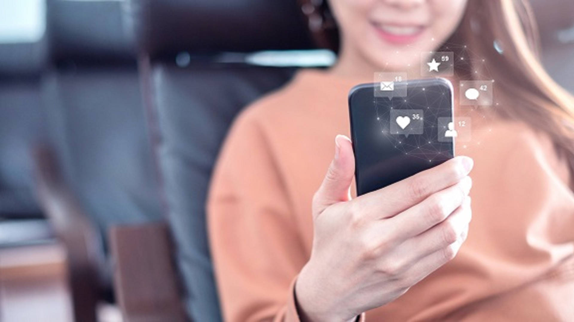 A women is checking her social media reach on her phone